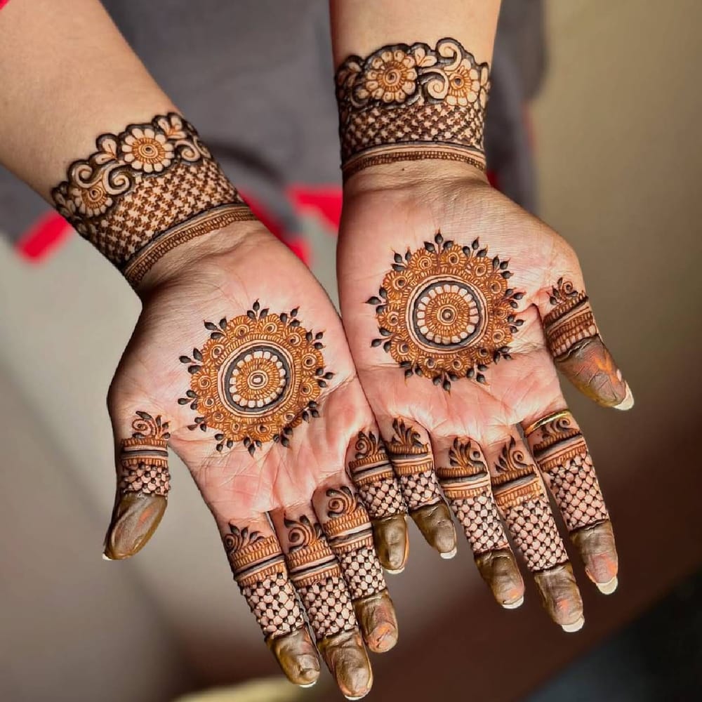 ਜੇਕਰ ਤੁਹਾਨੂੰ ਜਲਦੀ ਵਿੱਚ ਮਹਿੰਦੀ ਲਗਾਉਣੀ ਪਵੇ, ਤਾਂ ਤੁਸੀਂ ਇਸ ਮਹਿੰਦੀ ਡਿਜ਼ਾਈਨ ਦੀ Copy ਕਰ ਸਕਦੇ ਹੋ। ਇਸਨੂੰ ਘਰ ਵਿੱਚ ਲਗਾਉਣਾ ਵੀ ਬਹੁਤ ਆਸਾਨ ਹੋਵੇਗਾ। ਇਸ ਵਿੱਚ, ਹੱਥ 'ਤੇ ਡਿਜ਼ਾਈਨ ਦੇ ਨਾਲ ਇੱਕ Circle ਬਣਾਇਆ ਗਿਆ ਹੈ। ਇਸ ਤੋਂ ਇਲਾਵਾ, ਉਂਗਲਾਂ ਅਤੇ ਗੁੱਟਾਂ 'ਤੇ ਸਧਾਰਨ ਡਿਜ਼ਾਈਨ ਲਗਾਏ ਗਏ ਹਨ। ਜੋ ਦੇਖਣ ਨੂੰ ਸੁੰਦਰ ਅਤੇ ਸਾਦਾ ਲੱਗਦਾ ਹੈ। ਅੱਜਕੱਲ੍ਹ, ਇਹ ਮਹਿੰਦੀ ਡਿਜ਼ਾਈਨ ਕਾਫ਼ੀ ਟ੍ਰੈਂਡ ਵਿੱਚ ਹੈ। ( Credit : mehendiartistkomalkhot )